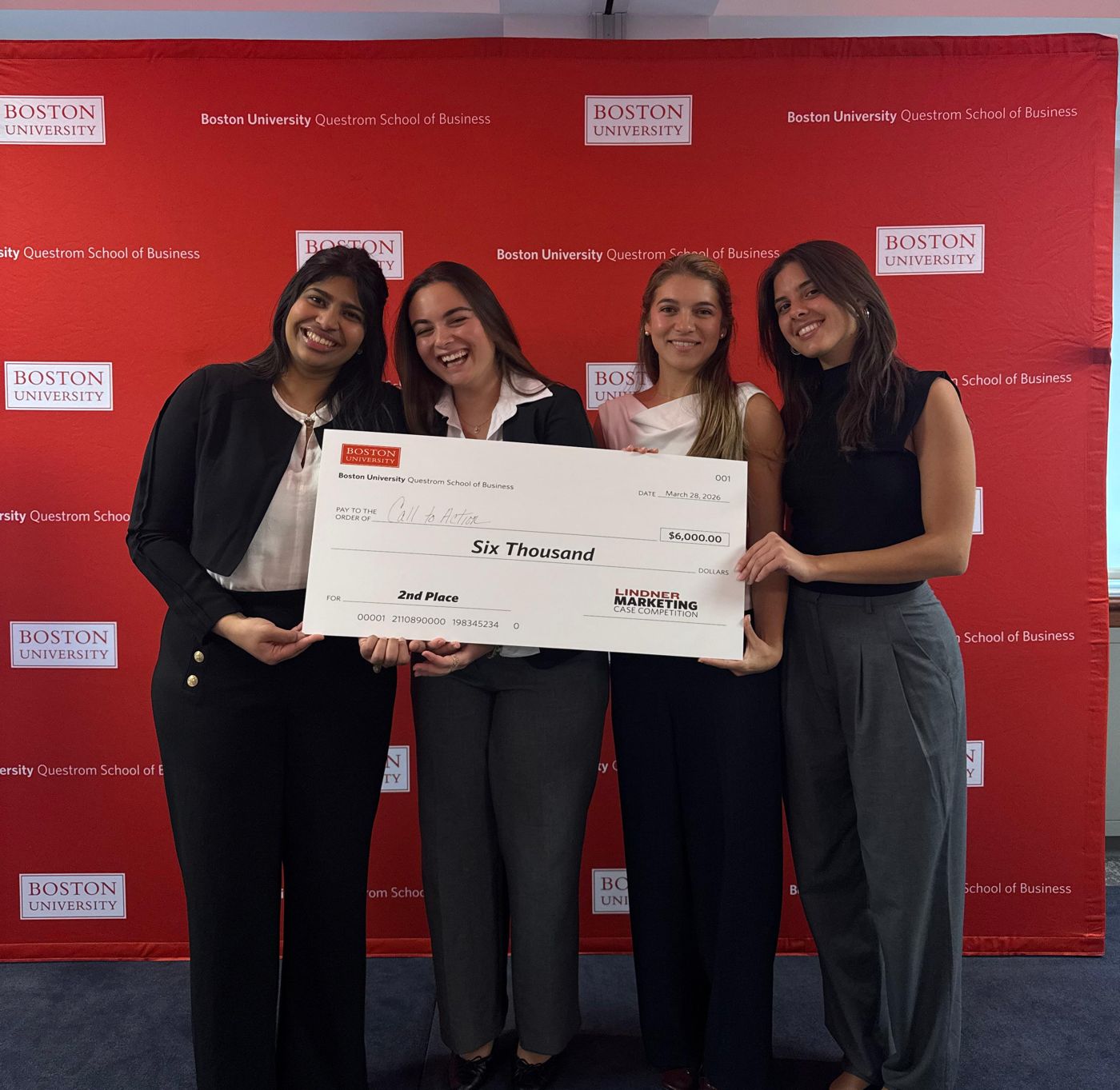 Theodora and her three teammates holding the second place check at the Boston University Lindner Marketing Case Competition
